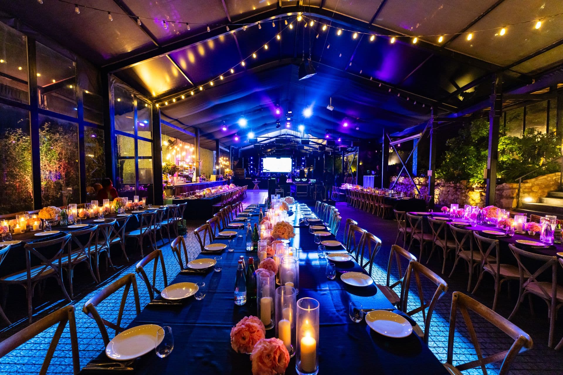 Elegant corporate event venue with ambient lighting and a long banquet table